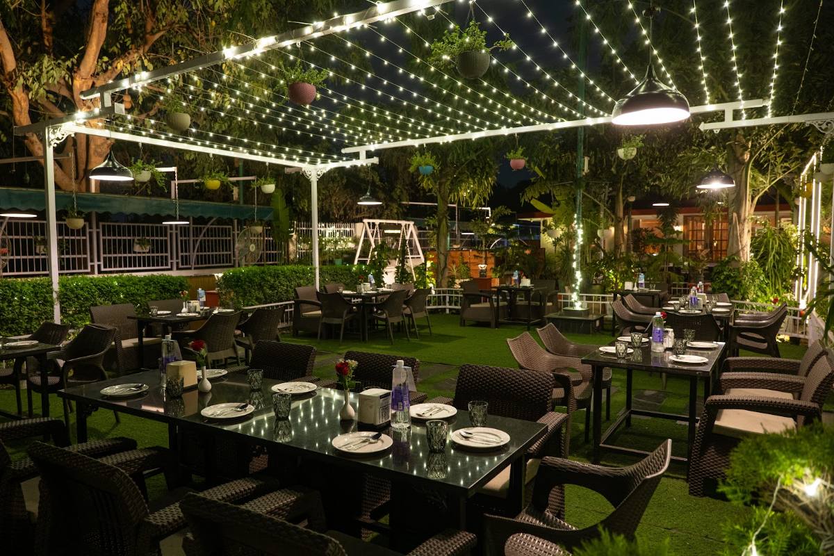 Garden dining beneath a canopy of string lights
