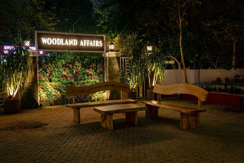 Woodland Affairs sign glowing at night