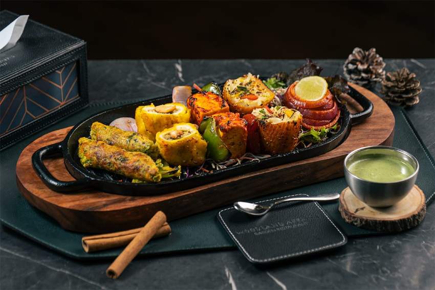 Paneer and vegetable tikka on a board