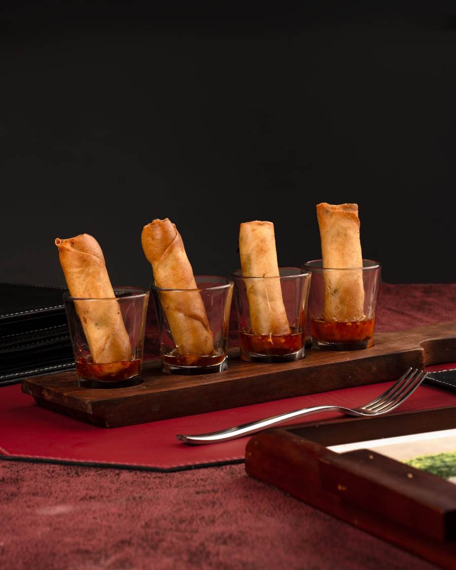 Golden fried rolls on a wooden board, crunchy and hot.