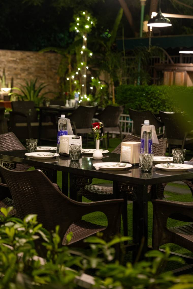 Garden table set for a celebration under warm lights